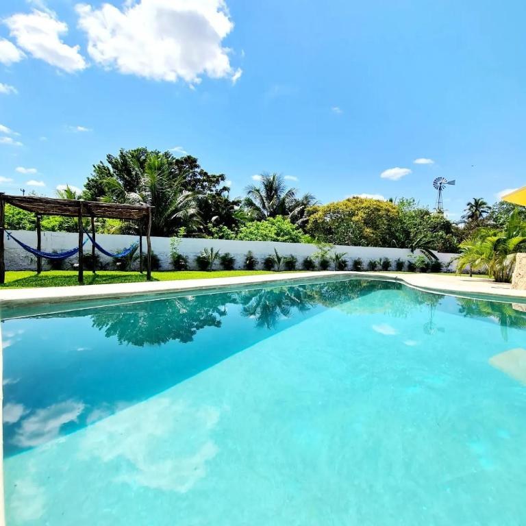 The outdoor pool and tropical gardens of Hotel Quinta Izamal